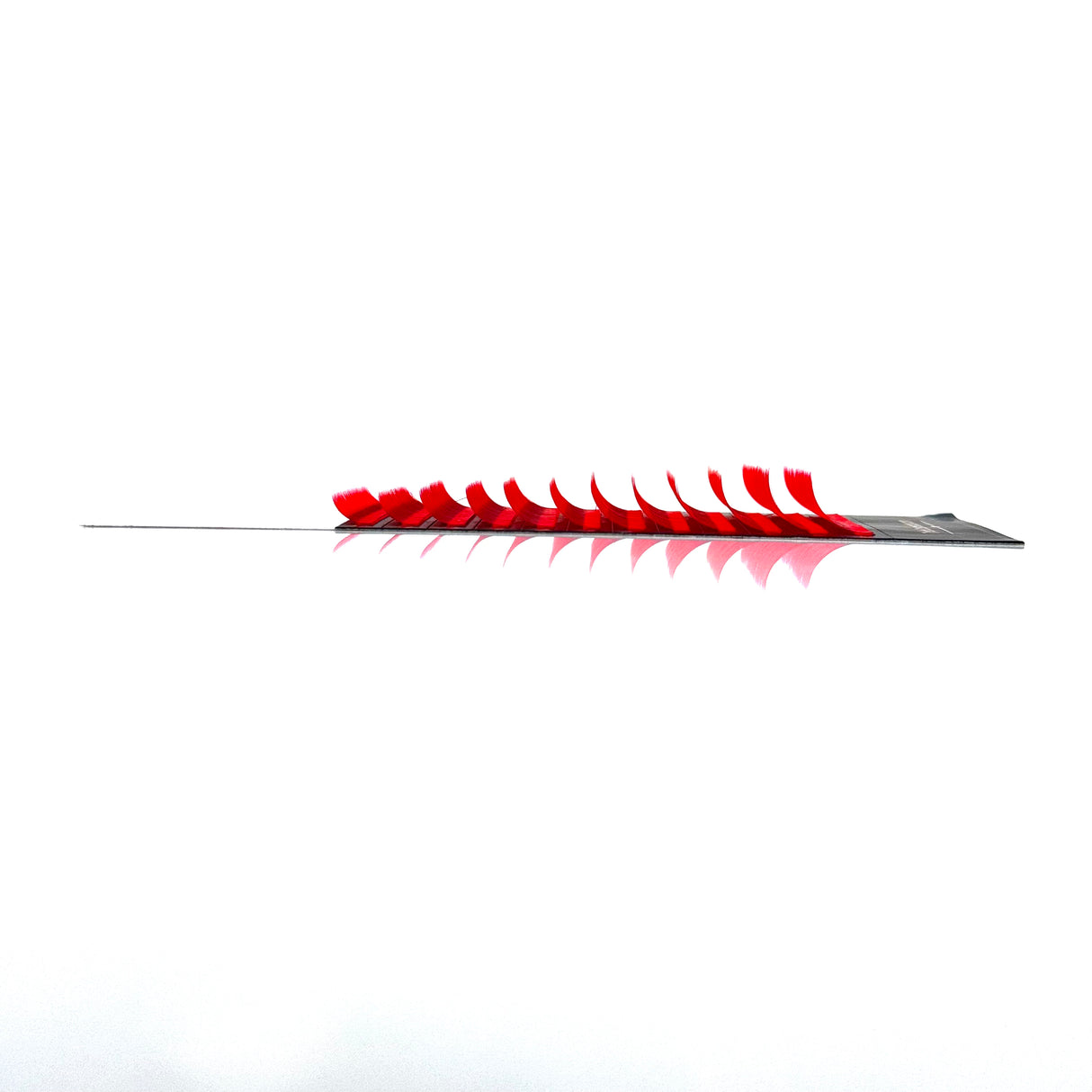 Side angle of red J curl .05 bottom lashes in 7–12mm mixed lengths by Trish Co