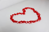 Red heart-shaped glue rings – lash adhesive holders arranged in a heart layout by Trish Co