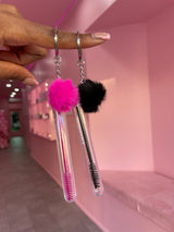 Three Brush & GO lash spoolie keychains lined up – white, black, and pink portable lash brushes with caps