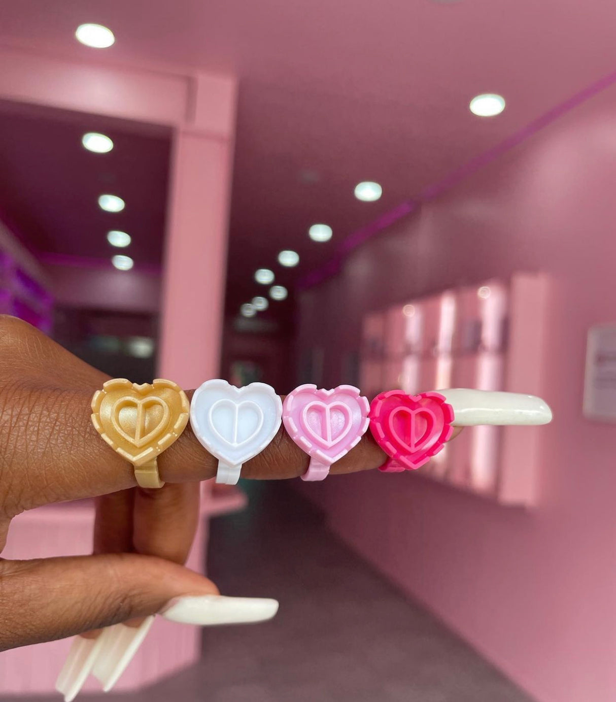 Heart glue ring worn on finger – part of 100-pack lash adhesive holders from Trish Co