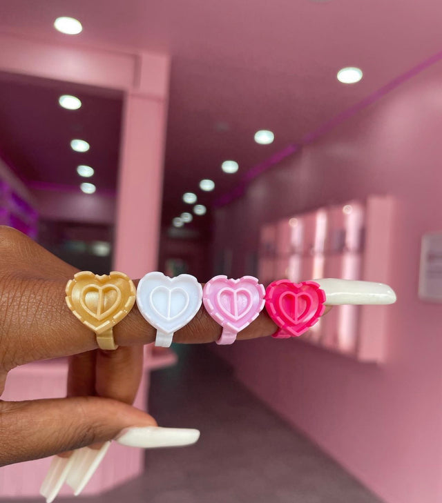 Heart glue ring worn on finger – part of 100-pack lash adhesive holders from Trish Co